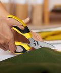 Person using Heavy Duty 8 Inch Utility Scissors With Serrated Blades for cutting fabric in a craft setting