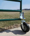 Heavy Duty Flat Free Spring Gate Caster with Universal Mount Eight Inch Wheel on green metal gate on concrete and grass surface