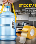 Double Sided Fabric Tape Heavy Duty For Hemming And Bonding 98 Ft Total Sticks Strong Yet Removable shown with water jug