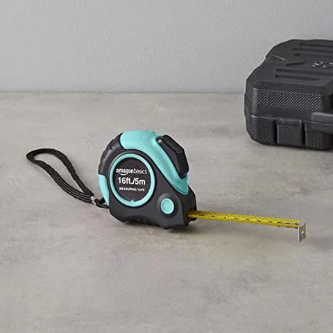 Heavy Duty Tape Measure - 16 ft / 192 in, Turquoise with yellow blade extended on gray surface