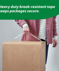 Person carrying box sealed with HD Clear Packing Tape Dispenser Heavy Duty Tape Gun for Boxes Shipping and Moving Includes One Refill Roll Foam Handle