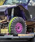 Heavy Duty Wheel Chock Tie Down Straps Set Two Pack With 4,400 Lb Max Break Strength securing an ATV on a trailer