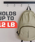 Beige backpack hanging on a hook with text 'Holds Up To 12 lb' on the wall, demonstrating weight capacity of Extreme Double Sided Mounting Strips Mega Pack 1 Inch By 3 Inch Tape Holds Up To 30 Lbs Indoor Or Outdoor Use 48 Strips Heavy Duty Industrial Strength Adhesive For Painted Drywall And Other Surfaces.