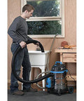 Person using Heavy-Duty Wet/Dry Vacuum Pump Accessory PE401 with drain attachment pumping water at sink in workshop.