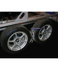 American Made Built Tough Heavy Duty Wheel Stabilizer Pair With One Handle For RV And Trailer Stabilization Reduces Tire Sway Between Tandem Tires With Zinc Coated Steel installed between tandem wheels on trailer