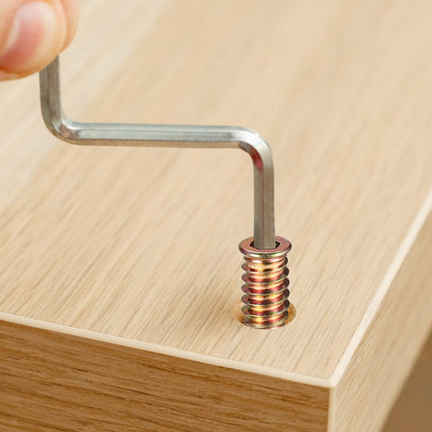 Inserting a metric threaded wood insert into wood surface using hex key from 200 Piece Metric Threaded Wood Inserts Kit M4 M5 M6 M8 M10 With Flanged Hex Socket Drive For Quick Furniture Fix And DIY Woodworking Projects Zinc Plated Finish For Extra Grip And Long Lasting Strength In Cabinets Shelves And DIY Builds