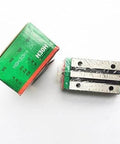 HGH30HA HIWIN Linear Block for HGH30 Linear Motion Slider Rail Guide Linear Bearing, shown in packaging with exposed metal rails.