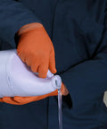 Person pouring liquid wearing Hi Vis Orange Nitrile Gloves Raised Diamond Texture 8 Mil Large Box Of 50