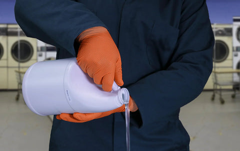 Person pouring liquid wearing Hi Vis Orange Nitrile Gloves Raised Diamond Texture 8 Mil Large Box Of 50