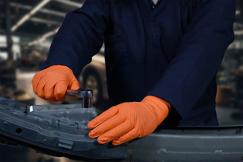 Mechanic wearing Hi Vis Orange Nitrile Gloves Raised Diamond Texture 8 Mil Large Box Of 50, using tools on metal part