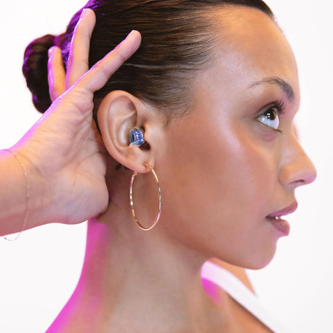 Person wearing High Fidelity Reusable Earplugs With Blue Filters For Concerts And Live Music Offering Superior Noise Reduction