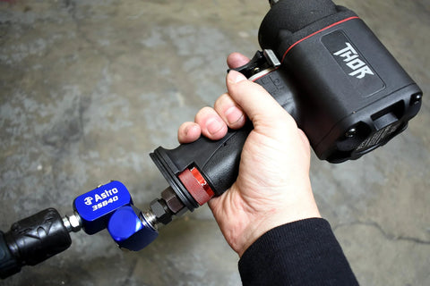 High Flow 3-Way Air Swivel in use with impact wrench, showcasing 360 degree motion and compact design for heavy-use shop setups