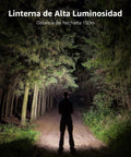 Person walking on forest path lit by powerful flashlight at night