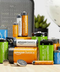 Assorted alkaline and rechargeable batteries, including AA and AAA, displayed on a table; related to 24 Pack 12 AA And 12 AAA High Performance Alkaline Batteries Value Pack.