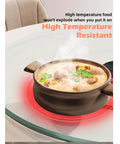 22.8 inch tempered glass lazy susan rotating serving tray with a hot food bowl demonstrating high temperature resistance.