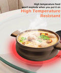 26.7 inch tempered glass lazy susan rotating serving tray showing a steaming pot on a high temperature resistant surface.