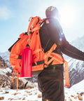 Hiker with orange backpack using 4 Pack 3.5 Inch Brass Double Ended Bolt Snap Clips on a snowy mountain trail