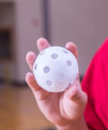 Hand holding a 9" Hollow Plastic Baseball - Athletic Baseball Equipment - Practice Baseballs Plastic Hollow - Regulation Size Balls