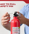 Person pulling pin on Multi Purpose Fire Extinguisher 1A10BC For Home Office Dorm And Residential Use All Metal Construction