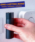 Close-up of Heavy Duty Adhesive Hook And Loop Tape Strips 16 Sets 1 By 3 Inch Double Sided Fasteners With Strong Back Adhesive being used on a wall.