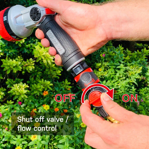 Hand operating a shut-off valve on a garden hose quick connect kit with water stop and flow control 9 piece snap and lock fittings.