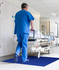Hospital corridor with blue Heavy Duty Sticky Mat Tacky Adhesive Pads 300 Sheets Bulk Pack Includes 18x24 And 24x36 Inch Blue Mats