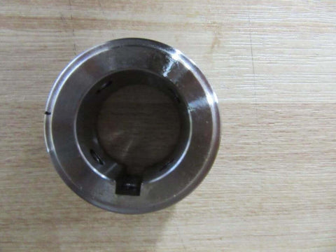 Top view of Two HSB Hub Assembly With 1.125 Inch Bore For One Quarter Inch By One Eighth Inch KW 1 SS Shafts Rexnord 7300235 Pipe And Coupling Machine Part For Beefy Heavy Duty Industrial Transmission on wood surface