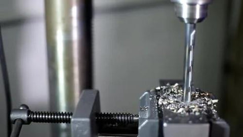 Close-up of KFD Series High Speed Steel Drill Bits Split Point One Eighth Inch drilling metal, showing precision and effectiveness.