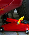 Universal Steel Front Wheel Replacement For Hydraulic Floor Jacks 2.5 Ton To 3.5 Ton installed on a red hydraulic jack