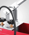 Close-up of hydraulic pressure test pump with 50 bar hand pressure, metal valves, and red steel tank for irrigation and firemen use.