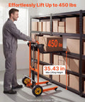 Man using Hydraulic Material Lift Winch Stacker With 450 Lb Capacity And 35.4 Inch Lift Height in warehouse, orange and black.
