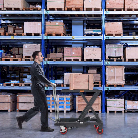 Warehouse worker using Hydraulic Lift Table Cart 500 Lb Capacity With 28.5 Inch Lift And Four PU Wheels For Safe Material Handling