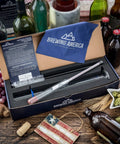 NIST traceable hydrometer kit USA with test jar, brush, and instructions for homebrewing displayed on rustic table with grapes and bottles.