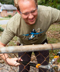 Man wearing Impact Resistant Safety Glasses With UV400 Anti Fog Clear Lenses ANSI Z87.1 while trimming a wire fence