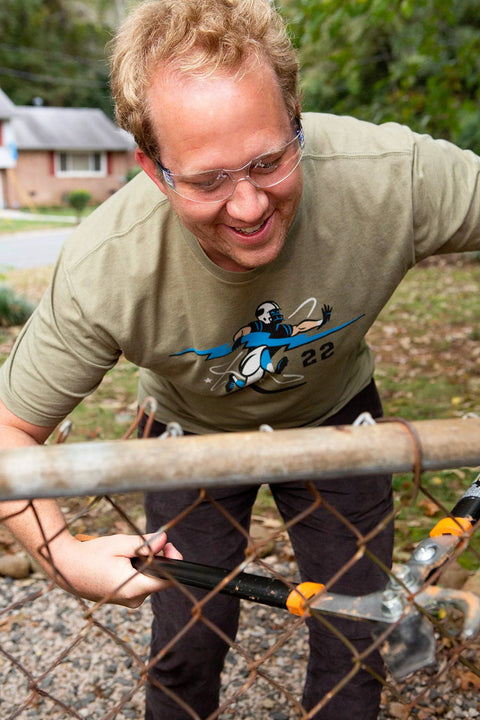 Man wearing Impact Resistant Safety Glasses With UV400 Anti Fog Clear Lenses ANSI Z87.1 while trimming a wire fence
