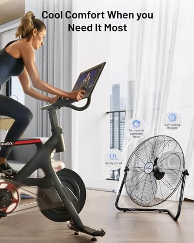 Cyclist using exercise bike near 20 Inch Heavy Duty Floor And Wall Mount Fan For Industrial Cooling With 5750 CFM High Velocity Three Speed And 360 Degree Tilt Head Black UL Listed For Garage Workshop Office And Home.
