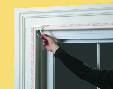 Installing Indoor Window Insulation Kit 4 Pack Shrink Film For Windows with included double sided tape on window frame