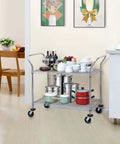Heavy Duty 2 Tier Rolling Cart With Wheels And Handles For Commercial Use 600 Lb Capacity Built To Last Industrial Steel Utility Cart Kitchen Carts On Wheels NSF Certified 23.6 In D X 47.2 In W X 39.4 In H in a kitchen setting holding cookware and bottles.