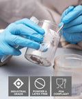 Person using DuraSkin Nitrile Gloves 3.5 Mil Large Powder Free Micro Textured Blue Industrial for handling chemicals.