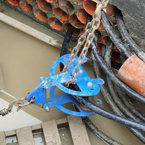 Industrial Cable Pulley Sheave With Anchor Shackle For Large Scale Laying installed on site for heavy duty cable feeding and pulling