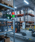 Two-Stack LED Andon Tower Signal Light With Buzzer For Industrial Lines in warehouse, red and green signal lights visible.