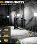 Heavy Duty 10000LM LED Work Light With Stand For Dewalt 20V Battery Not Included 100W Portable Tower Flood Light On Tripod With 13Ft Cord For Workshop Construction Outdoor Job Site Lighting shown illuminating a construction site.