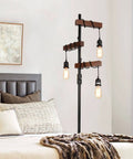 Industrial Dimmable Floor Lamp With 3 Heads 68 Inch Tall Tree Floor Lamp In Black Metal And Wood next to bed in bedroom