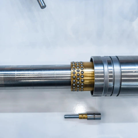 Close-up of Self Lubricating Sleeve Bearing Set Of Three Three Quarter Inch Bore Seven Eighths Inch Outer Diameter installed on shaft.