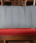 Gray inflatable seat cushion on wooden chair for travel and camping comfort, size 260x410 mm.