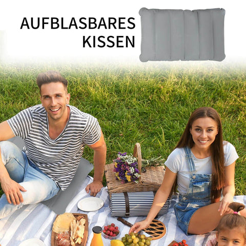 Inflatable seat cushion used for a picnic, with two people sitting on a blanket in a park. Cushion shown in top corner.