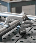 Heavy Duty Five Eighths Inch Insert Table Mounted Clamp With Rear Crank Handle For BuildPro Welding Tables in use on metal pipe