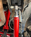 1.25 inch Heim joint rod end kit with tube adapters, misalignment spacers, installed in vehicle suspension system.