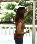 Woman cleaning glass sliding door near patio, related to Two Pack Hinge Style Sliding Glass Door Locks For Patio Doors And Windows Instantly Increase Home Security And Child Proof Your Space With Easy Installation.