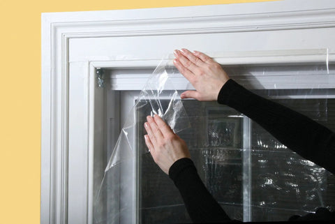 Applying Indoor Window Shrink Kit For 42 To 62 Inch Windows Clear 9 Pack Insulation Film to block drafts and boost efficiency